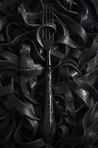 Free Photo | Dark tagliatelle pasta with fork