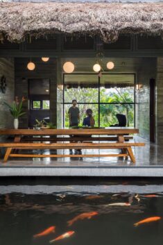 AM House is a Vietnamese holiday home surrounded by a pond and tropical gardens