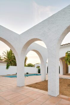 Arched openings connect indoor and outdoor spaces in 1960s Spanish holiday home