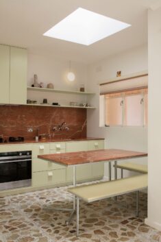Pistachio green kitchen and terrazzo tiles modernise mid-century Melbourne apartment