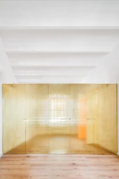 Golden wardrobe forms focal point of The Magic Box Apartment in Spain