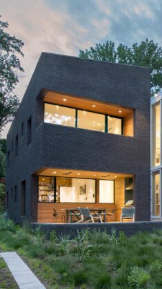 La Clairiere residence clad in black Glen-Gery bricks defined by “balanced imperfection”