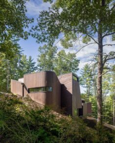 Fuller Overby stacks cypress-wrapped spaces for North Carolina lake house
